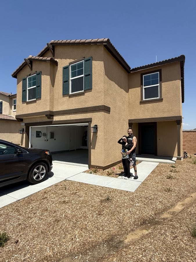 Cruz Team Realty clients on closing day in front of their new home